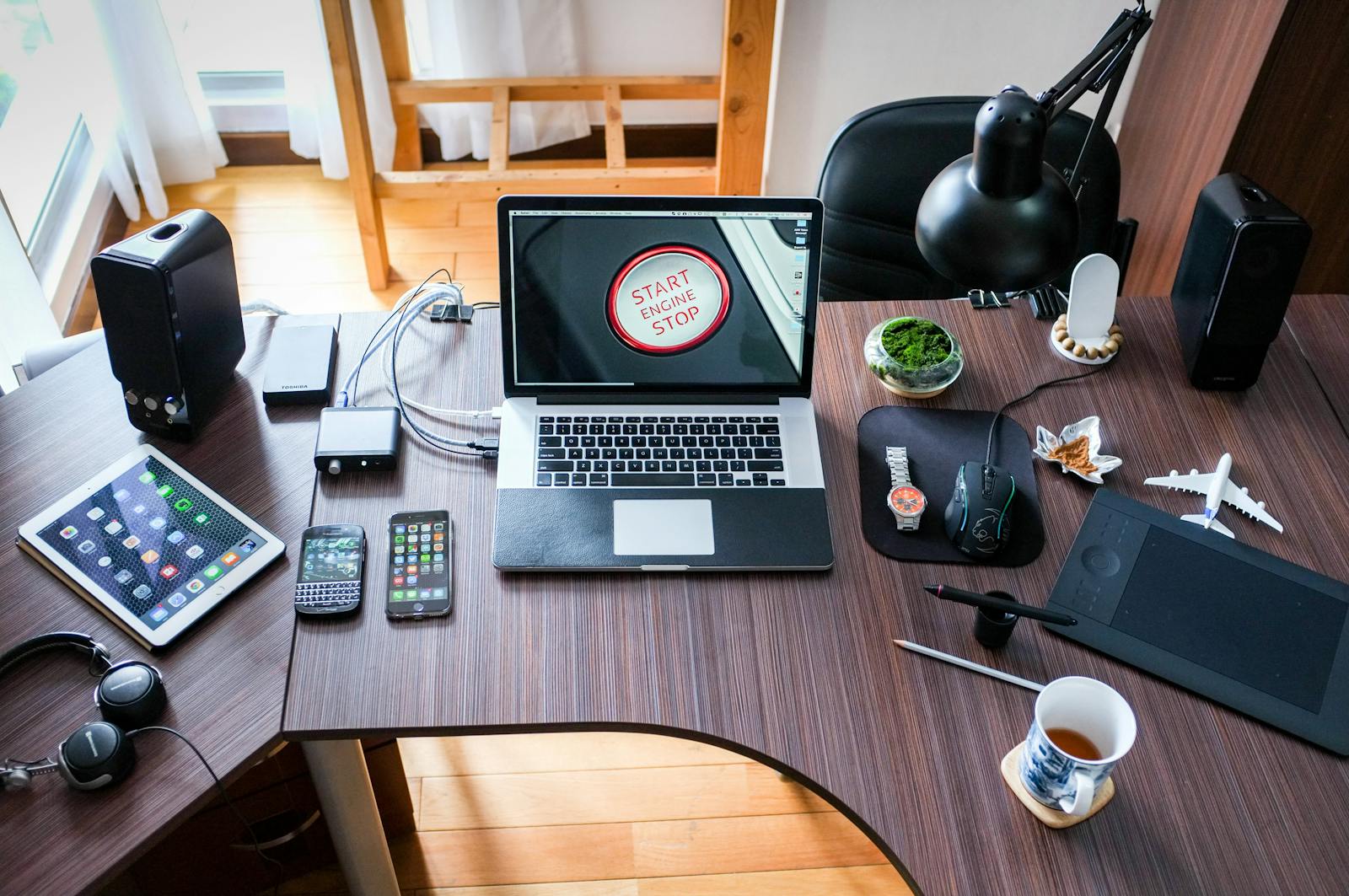 business A contemporary office desk setup with laptops, gadgets, and accessories, creating a tech-savvy workplace.